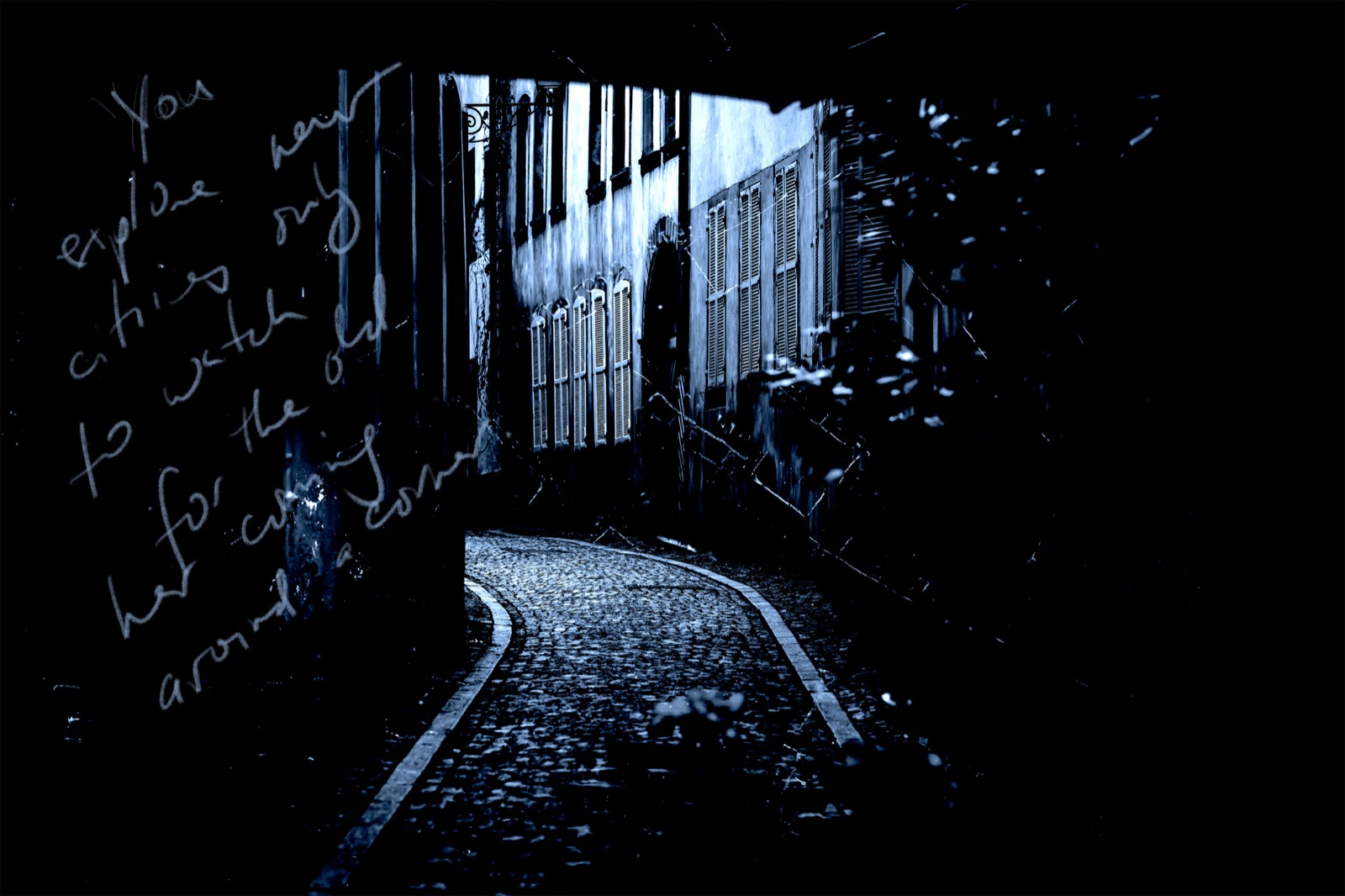New Cities: a dark cobbled lane in Strasbourg with handwriting across the image